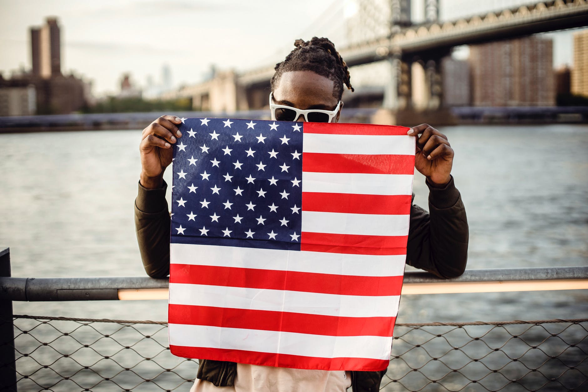 black manScholarships for Non US Citizens 2022-23 (Fully Funded) american flag on city river embankment